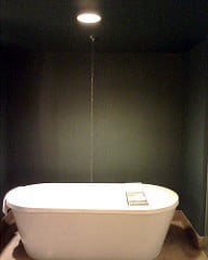 bathtub in dark room under spotlight