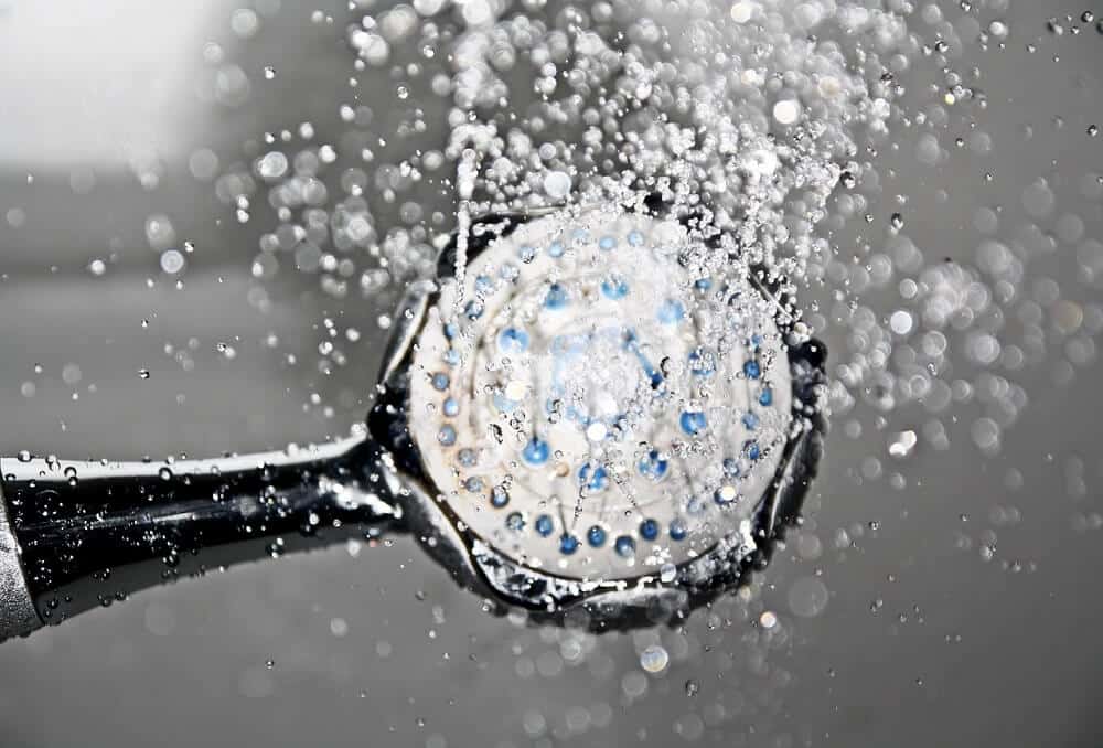 looking up into shower head with water on