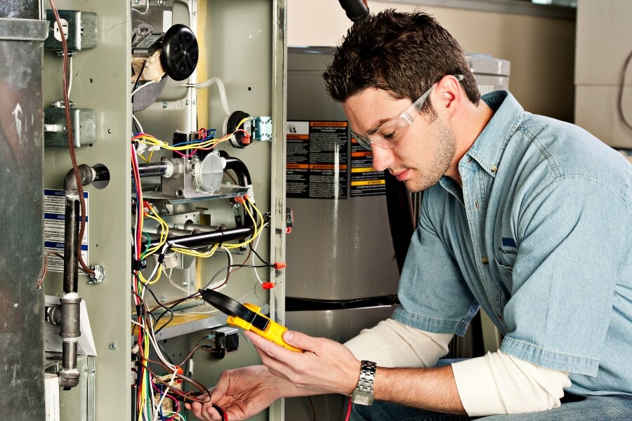 Certified technician performing furnace repair inspection