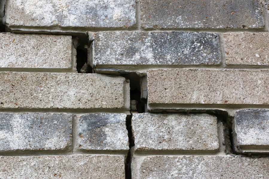 Exterior wall damage showing signs of slab leak issues