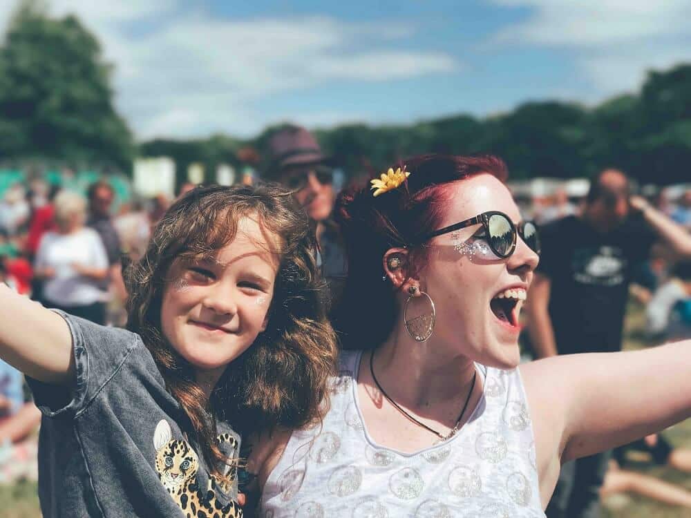 excited woman holds girl