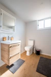 clean toilet and vanity in white bathroom