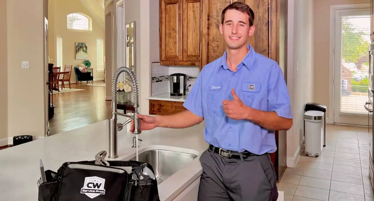 CW Service Pros technician at kitchen counter